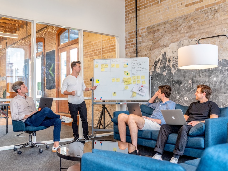 A large, diverse team meeting in a modern conference room