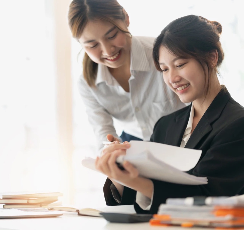 Two professionals reviewing financial documents together