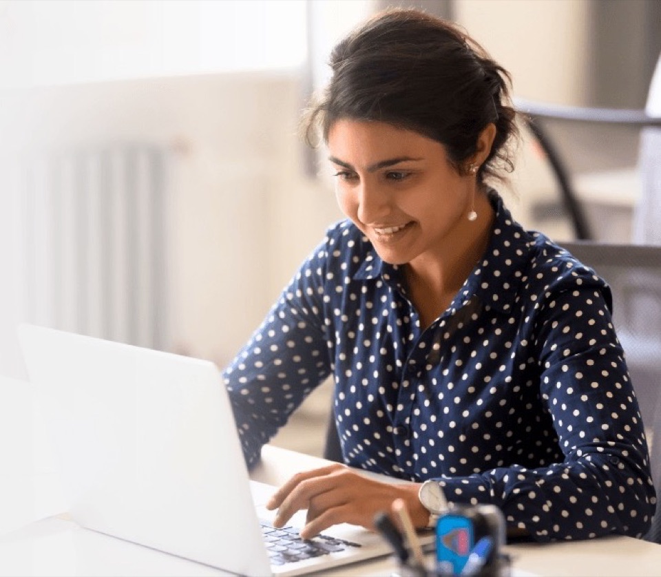 A professional working on a laptop, representing NetSuite developers available to hire