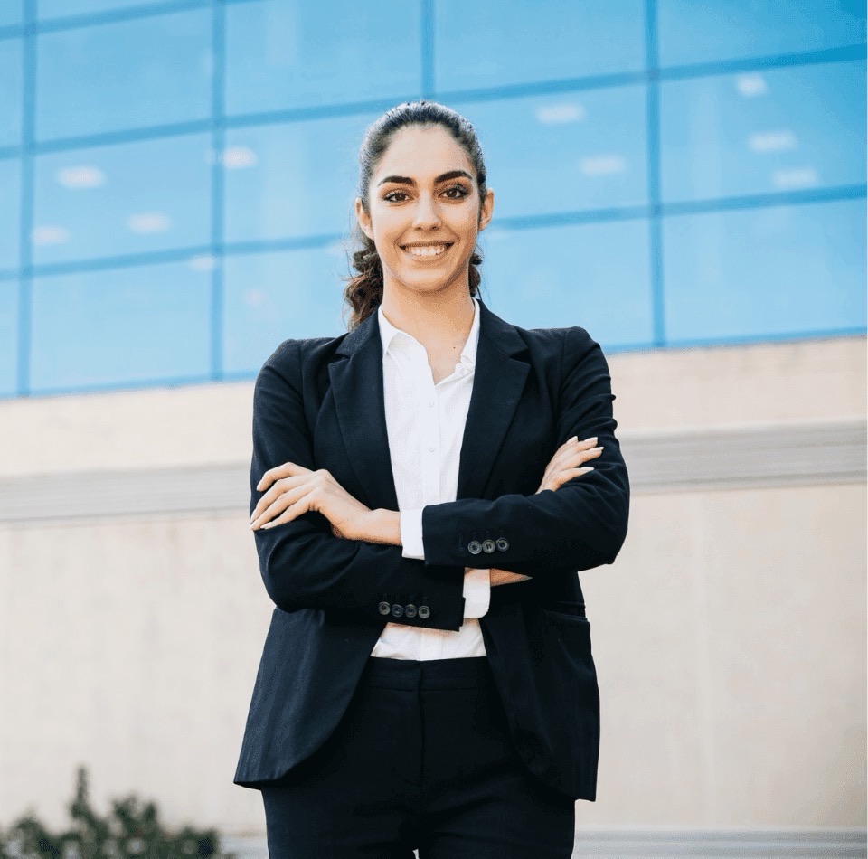 A confident professional in a business suit outside a modern office building