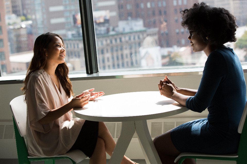 Two colleagues in conversation at a table
